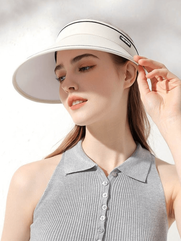 Woman wearing a stylish white adjustable sunproof visor hat, perfect for sun protection and easy storage.